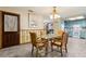 Open dining area leading to a kitchen with blue cabinetry, creating a bright and cheerful space at 255 Katrina St, De Leon Springs, FL 32130