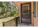 A secure front entry features a black security door for added safety at 255 Katrina St, De Leon Springs, FL 32130