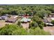 A low-angle shot exhibits a well-maintained home with mature trees and natural landscaping at 255 Katrina St, De Leon Springs, FL 32130