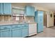 Functional kitchen with ample counter space, blue cabinets, and modern dishwasher at 255 Katrina St, De Leon Springs, FL 32130