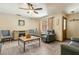 Cozy living room with tile floors, a ceiling fan, and natural light from the window at 255 Katrina St, De Leon Springs, FL 32130