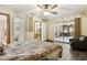 Spacious main bedroom featuring a ceiling fan, wood-look flooring, and sliding glass doors to the patio at 255 Katrina St, De Leon Springs, FL 32130