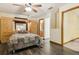Comfortable main bedroom features a ceiling fan, wood-look flooring, and a built-in wardrobe at 255 Katrina St, De Leon Springs, FL 32130