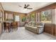 Enclosed patio with tile floor, ceiling fan, and bright views of the backyard at 255 Katrina St, De Leon Springs, FL 32130