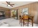 Enclosed sun room features tile flooring, fan, table with chairs, and sliding glass doors at 255 Katrina St, De Leon Springs, FL 32130