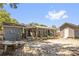 Backyard with shed, screened-in patio, seating area, and partial shade from a tree at 260 3Rd St, Winter Springs, FL 32708