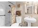 Bathroom with a marble-walled shower, toilet, decorative hand towels, and a pedestal sink at 260 3Rd St, Winter Springs, FL 32708