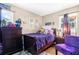 Well-lit bedroom with a comfy bed, dark furniture and a window with purple curtains at 260 3Rd St, Winter Springs, FL 32708