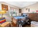 Comfortable bedroom with a window letting in natural light and a colorful floral comforter at 260 3Rd St, Winter Springs, FL 32708