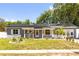 Charming single-story home with a welcoming front porch and solar panels on the roof at 260 3Rd St, Winter Springs, FL 32708