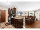 This open-concept kitchen features dark cabinetry and a view to the living area at 260 3Rd St, Winter Springs, FL 32708