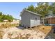 Exterior view of a gray backyard shed, with lawn equipment scattered nearby at 260 3Rd St, Winter Springs, FL 32708