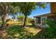 View of the backyard with mature trees, a fenced perimeter, and lush green grass at 2611 Albion Ave, Orlando, FL 32833