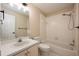 Bathroom with a vanity with sink, toilet, and a tiled bathtub with a shower head at 2611 Albion Ave, Orlando, FL 32833