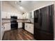 Modern kitchen with white cabinets, subway tile, wooden counters, black appliances, and wood-look flooring at 2611 Albion Ave, Orlando, FL 32833