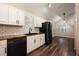 Well-lit kitchen featuring white cabinets, butcher block countertops, subway tile, and modern black appliances at 2611 Albion Ave, Orlando, FL 32833