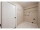 Laundry room with tile flooring, shelving, hooks for hanging and utility connections at 2611 Albion Ave, Orlando, FL 32833