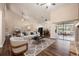 Open-concept living area with wood floors, vaulted ceilings, and sliding glass doors to a screened patio at 2611 Albion Ave, Orlando, FL 32833