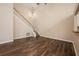 Open living area features a staircase, dark wood-look flooring, and neutral paint at 2611 Albion Ave, Orlando, FL 32833