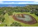 Stunning aerial view of a community pond surrounded by lush greenery and beautiful lake views at 2983 Park Meadow Dr, Apopka, FL 32703