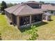 Aerial view of the backyard with a screen enclosed patio and storage shed at 2983 Park Meadow Dr, Apopka, FL 32703