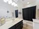 Bathroom features a dark wood vanity and black shower curtain at 2983 Park Meadow Dr, Apopka, FL 32703