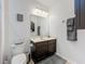 Bathroom featuring a dark wood vanity, framed mirror, and brushed nickel hardware at 2983 Park Meadow Dr, Apopka, FL 32703