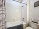 Clean, bright bathroom featuring white tile, a tub/shower combination, and modern fixtures at 2983 Park Meadow Dr, Apopka, FL 32703