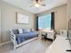Bright bedroom with a daybed, desk, ceiling fan and a large window at 2983 Park Meadow Dr, Apopka, FL 32703