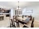 Elegant dining room with modern chandelier, open to the kitchen and staircase at 2983 Park Meadow Dr, Apopka, FL 32703