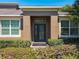 Close-up of the elegant front door, complemented by stylish landscaping and architectural details at 2983 Park Meadow Dr, Apopka, FL 32703