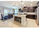Updated kitchen with stainless appliances, granite countertops, and an island with stool seating at 2983 Park Meadow Dr, Apopka, FL 32703