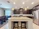 Modern kitchen with stainless appliances, granite countertops, and large island with stool seating at 2983 Park Meadow Dr, Apopka, FL 32703