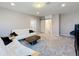 Spacious living room with neutral tones, plush carpeting, and a charming barn door to the stairwell at 2983 Park Meadow Dr, Apopka, FL 32703