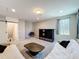 Cozy living room featuring plush seating, a modern entertainment center, and a stylish coffee table at 2983 Park Meadow Dr, Apopka, FL 32703