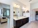 Elegant bathroom featuring double sinks, a bathtub, and access to a walk-in closet at 2983 Park Meadow Dr, Apopka, FL 32703