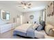 Serene main bedroom with soft colors, a ceiling fan, and a cozy seating area at 2983 Park Meadow Dr, Apopka, FL 32703
