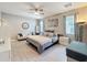 Well-lit main bedroom featuring a ceiling fan, seating area, and neutral tones at 2983 Park Meadow Dr, Apopka, FL 32703