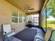 Cozy screened-in patio featuring outdoor seating, a ceiling fan, and a barbecue grill at 2983 Park Meadow Dr, Apopka, FL 32703