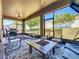 Relaxing screened-in patio with comfortable seating, outdoor grill, and scenic backyard views at 2983 Park Meadow Dr, Apopka, FL 32703
