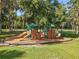 A charming playground with slides and climbing structures surrounded by lush greenery at 2983 Park Meadow Dr, Apopka, FL 32703