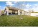 Spacious backyard showing screened patio, lawn and white vinyl fence in a private home setting at 3065 Timber Hawk Cir, Ocoee, FL 34761