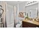 Well-lit bathroom with a combination tub and shower, granite countertop, and updated fixtures at 3065 Timber Hawk Cir, Ocoee, FL 34761