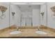 Well-appointed bathroom with double sinks, granite countertop, decorative sconces and large mirror at 3065 Timber Hawk Cir, Ocoee, FL 34761