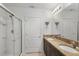Bathroom featuring double sink vanity with granite countertops, shower with glass door, and tiled flooring at 3065 Timber Hawk Cir, Ocoee, FL 34761