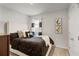 Comfortable bedroom with modern decor, a plush bed, and a bright window with custom window treatments at 3065 Timber Hawk Cir, Ocoee, FL 34761