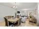 Open-concept dining area with tile floors, modern table set, and access to the living room at 3065 Timber Hawk Cir, Ocoee, FL 34761
