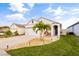Beautifully landscaped front yard featuring lush green grass, small palm trees and a two-car garage at 3065 Timber Hawk Cir, Ocoee, FL 34761