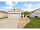 Charming one-story home featuring manicured lawn, stone accents, and a two-car garage at 3065 Timber Hawk Cir, Ocoee, FL 34761