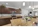 Spacious kitchen with dark wood cabinets, granite counters, tile backsplash, and stainless-steel appliances at 3065 Timber Hawk Cir, Ocoee, FL 34761